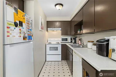 a kitchen with a white cabinets and white appliances