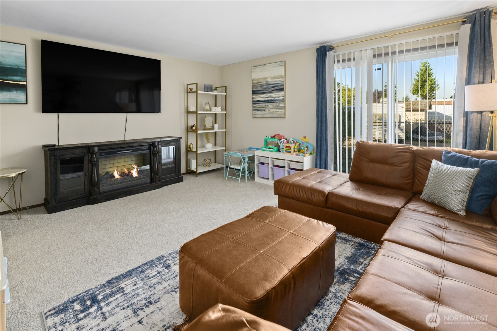 501 37th Street Southeast Auburn, WA 98002 - Photo 23 of 29 a living room with furniture a flat screen tv and a fireplace