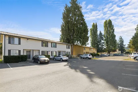 a car parked in front of a white house