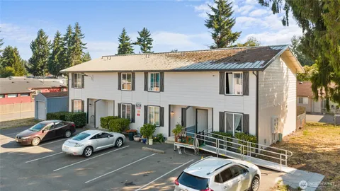 a front view of a house with parking space
