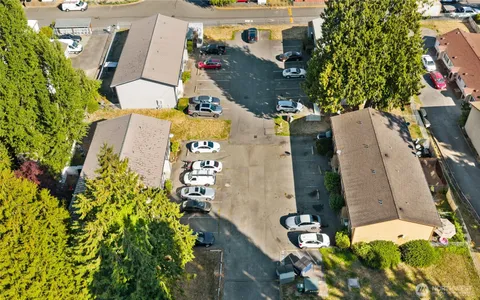 an aerial view of a house with a yard and large trees