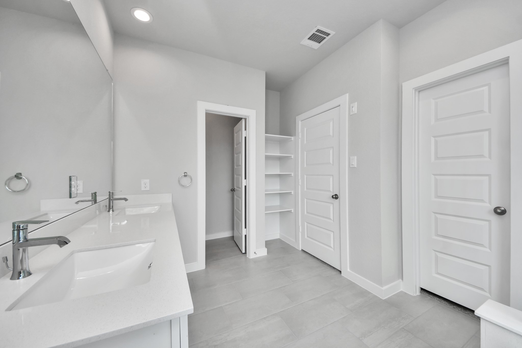 11114 Tulip Rdg Trail Houston, TX 77044 - Photo 21 of 30 Elevate your daily routine at the elegant vanity, now equipped with double sinks, light countertops, modern hardware, and beautiful recessed lights. Sample photo of completed home with similar floor plan. Actual colors and selections may vary.