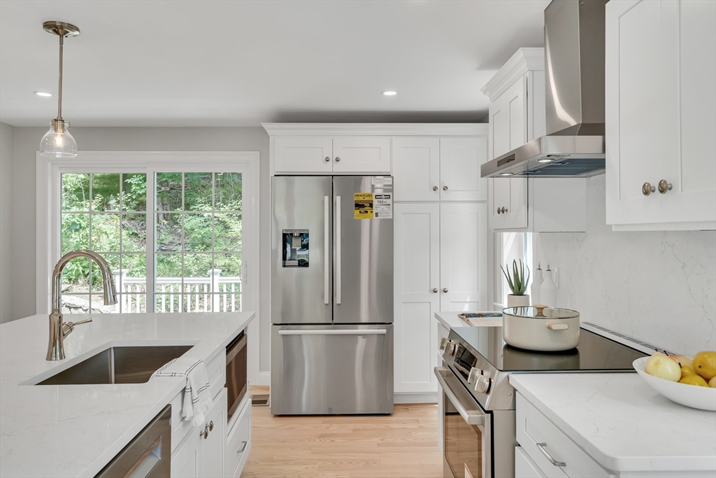 956 Waltham Street Lexington, MA 02421 - Photo 11 of 41 a kitchen with kitchen island a counter and a refrigerator