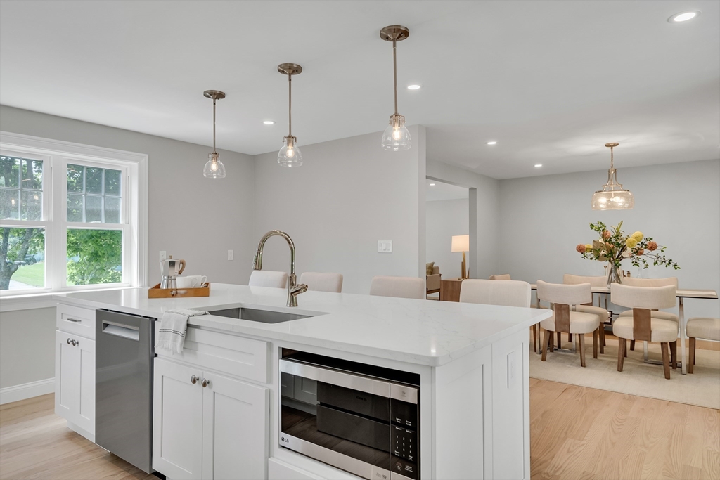 956 Waltham Street Lexington, MA 02421 - Photo 12 of 41 a kitchen with a sink a stove and chairs