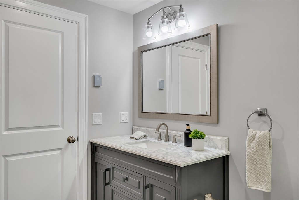 956 Waltham Street Lexington, MA 02421 - Photo 14 of 41 a bathroom with a granite countertop sink and a mirror