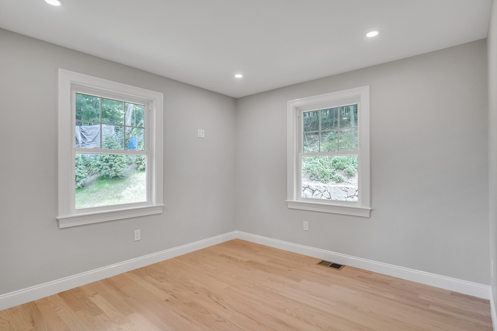 956 Waltham Street Lexington, MA 02421 - Photo 17 of 41 a view of an empty room with wooden floor and a window