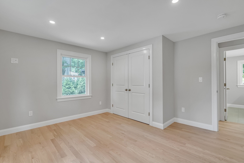 956 Waltham Street Lexington, MA 02421 - Photo 18 of 41 a view of an empty room with wooden floor and a window