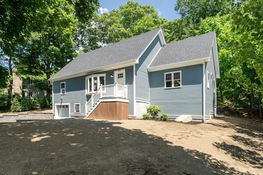 956 Waltham Street Lexington, MA 02421 - Photo 2 of 41 a front view of a house with a yard and garage