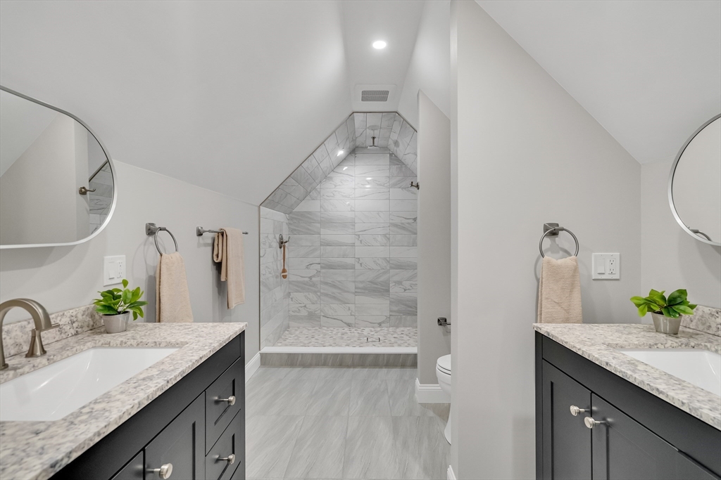956 Waltham Street Lexington, MA 02421 - Photo 30 of 41 a bathroom with a granite countertop sink a mirror and shower