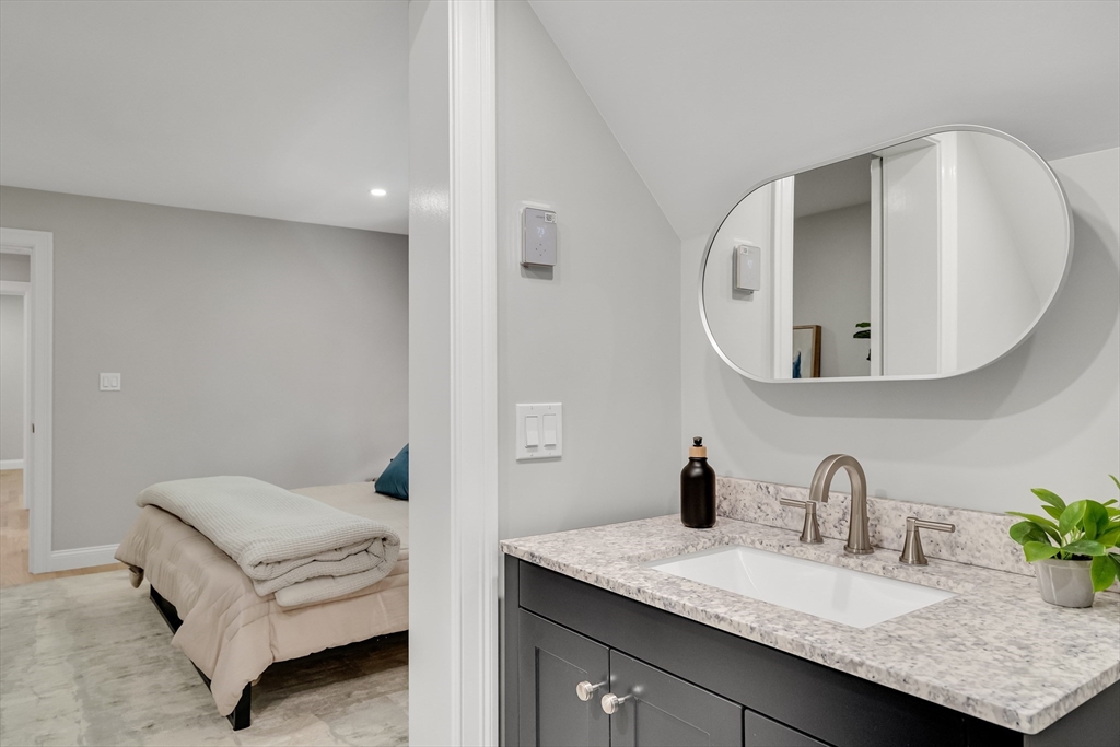 956 Waltham Street Lexington, MA 02421 - Photo 31 of 41 a en suite bathroom with a granite countertop sink and a mirror