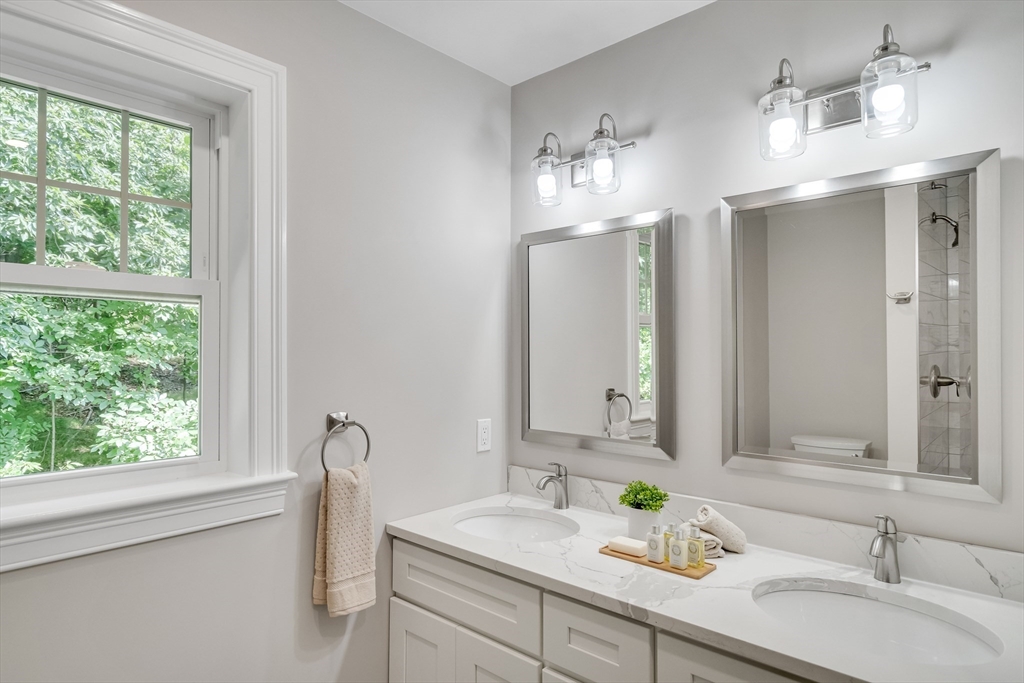 956 Waltham Street Lexington, MA 02421 - Photo 33 of 41 a bathroom with a sink double vanity and a mirror