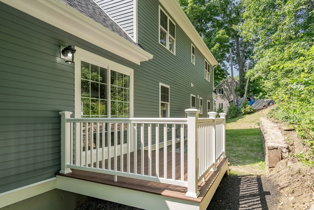 956 Waltham Street Lexington, MA 02421 - Photo 35 of 41 a porch with a bench next to a yard