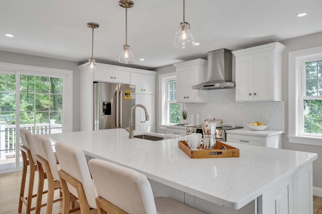 956 Waltham Street Lexington, MA 02421 - Photo 10 of 41 a kitchen with stainless steel appliances a table chairs and a wooden floor