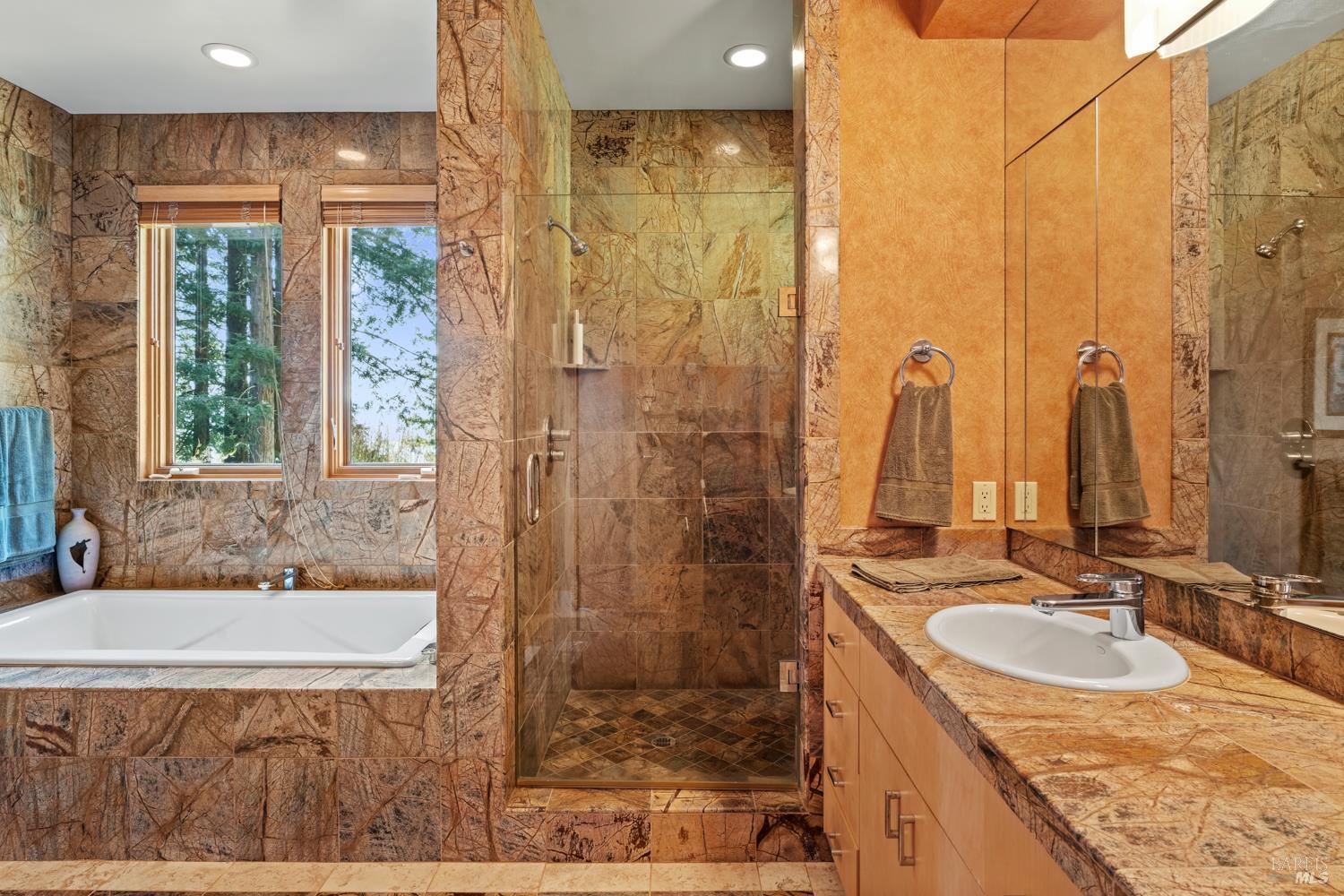 700 Holmes Ranch Road Philo, CA 95466 - Photo 32 of 42 a bathroom with a granite countertop sink and a mirror