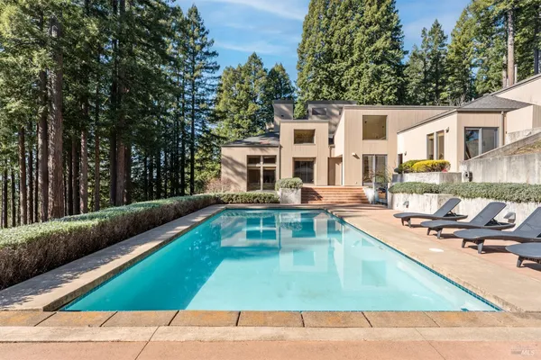 a swimming pool with outdoor seating and yard