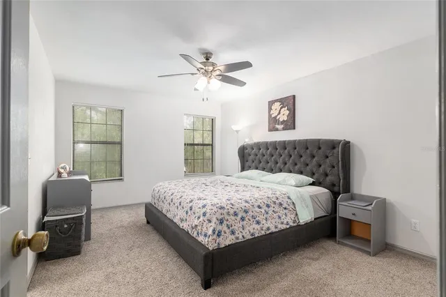 a view of backyard with table and chairs and large trees