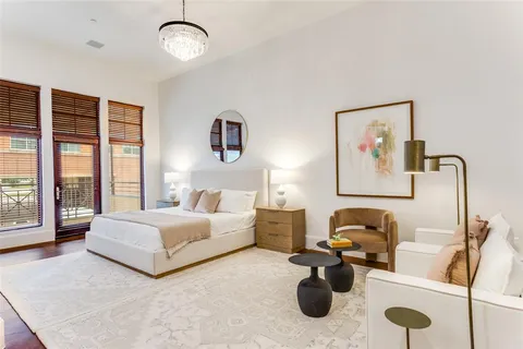 a bedroom with bed and a chandelier