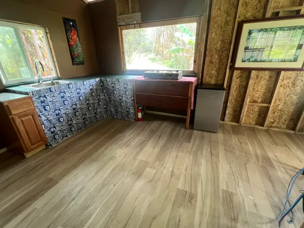 a bench sitting in a room next to a window