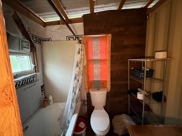 a white toilet sitting next to a bathroom sink and a shower