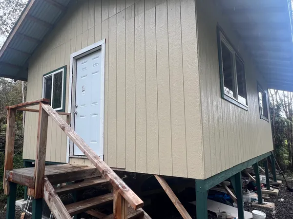 a view of a hallway with wooden floor and windows