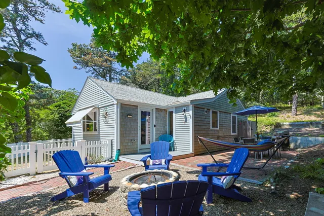 a backyard of a house with outdoor seating