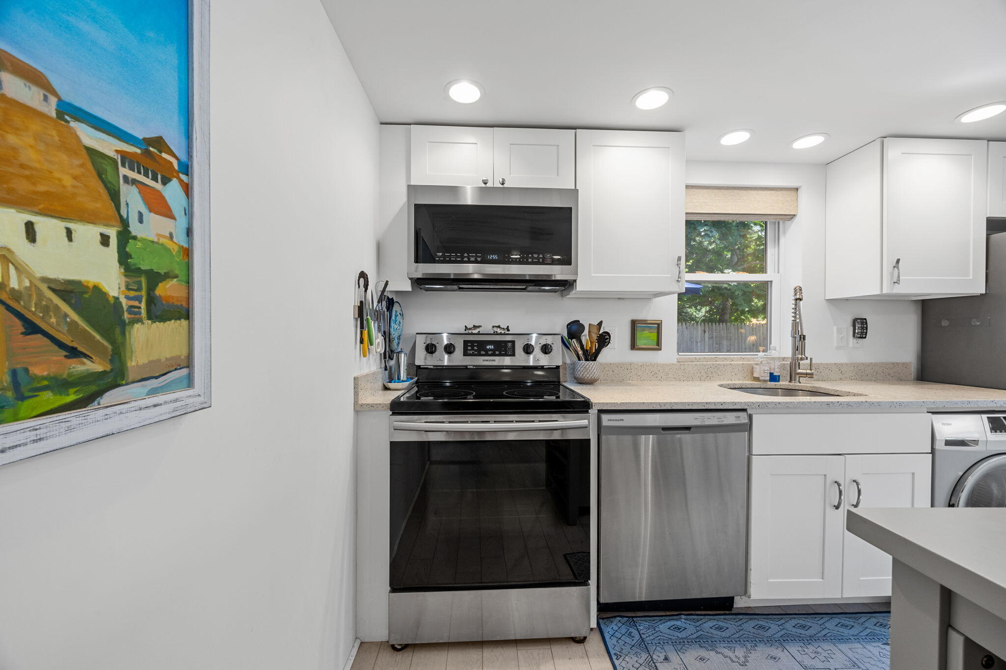 210 Chequessett Neck Road, Unit C Wellfleet, MA 02667 - Photo 14 of 37 a kitchen with stainless steel appliances granite countertop a stove a sink and a microwave