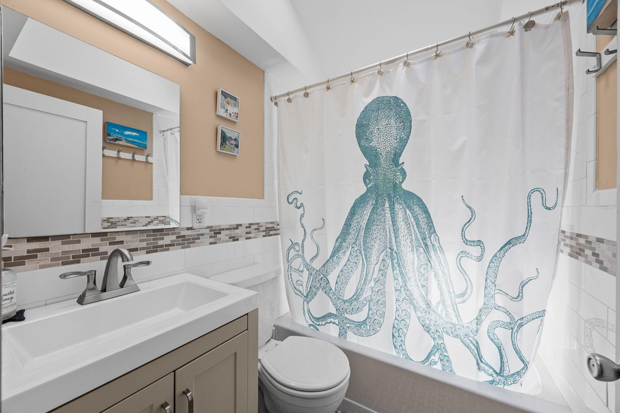 210 Chequessett Neck Road, Unit C Wellfleet, MA 02667 - Photo 17 of 37 a bathroom with a toilet sink and mirror