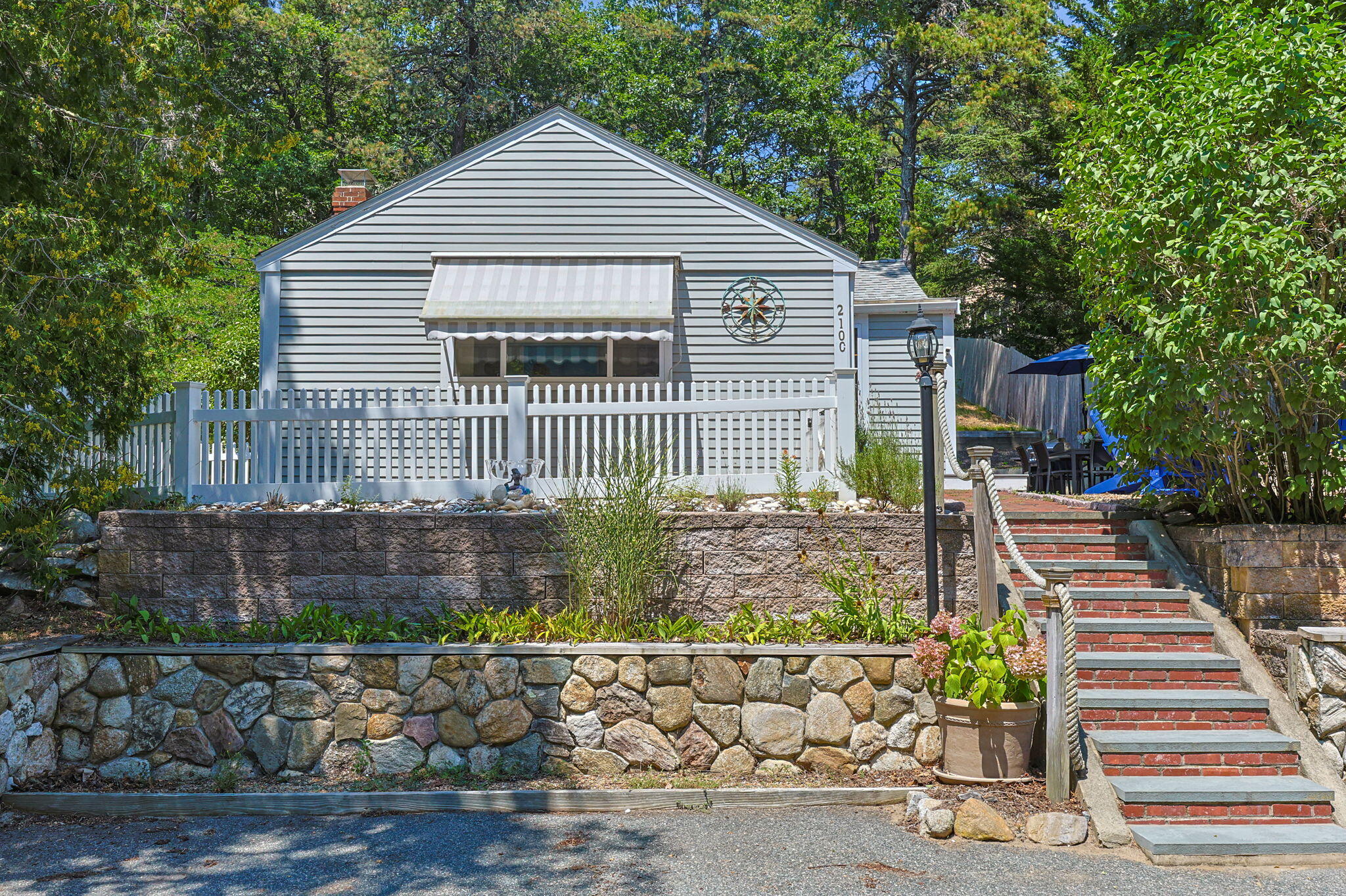 210 Chequessett Neck Road, Unit C Wellfleet, MA 02667 - Photo 2 of 37 a front view of a house with garage