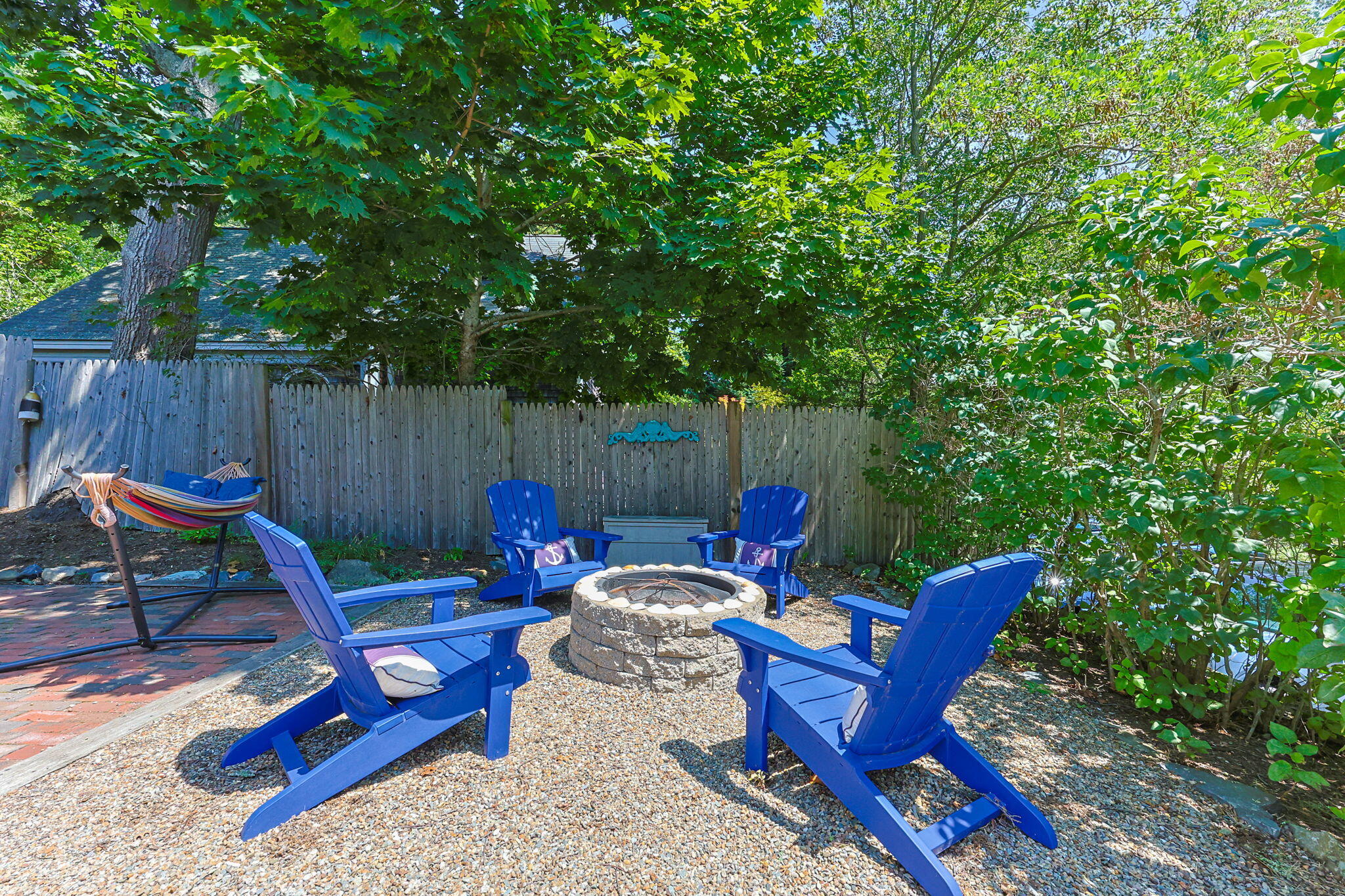210 Chequessett Neck Road, Unit C Wellfleet, MA 02667 - Photo 27 of 37 a view of a backyard with a slide and a table and chairs