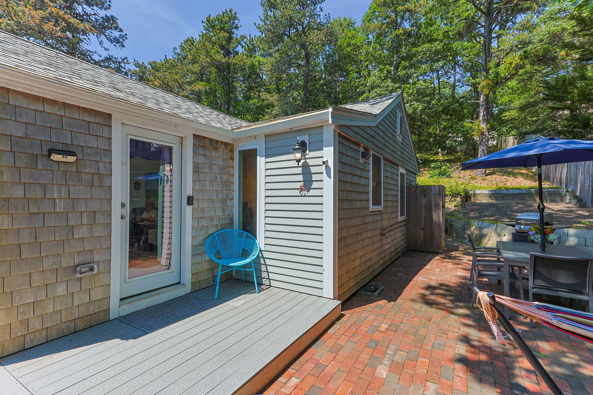 210 Chequessett Neck Road, Unit C Wellfleet, MA 02667 - Photo 28 of 37 a view of a backyard with a patio and wooden floor