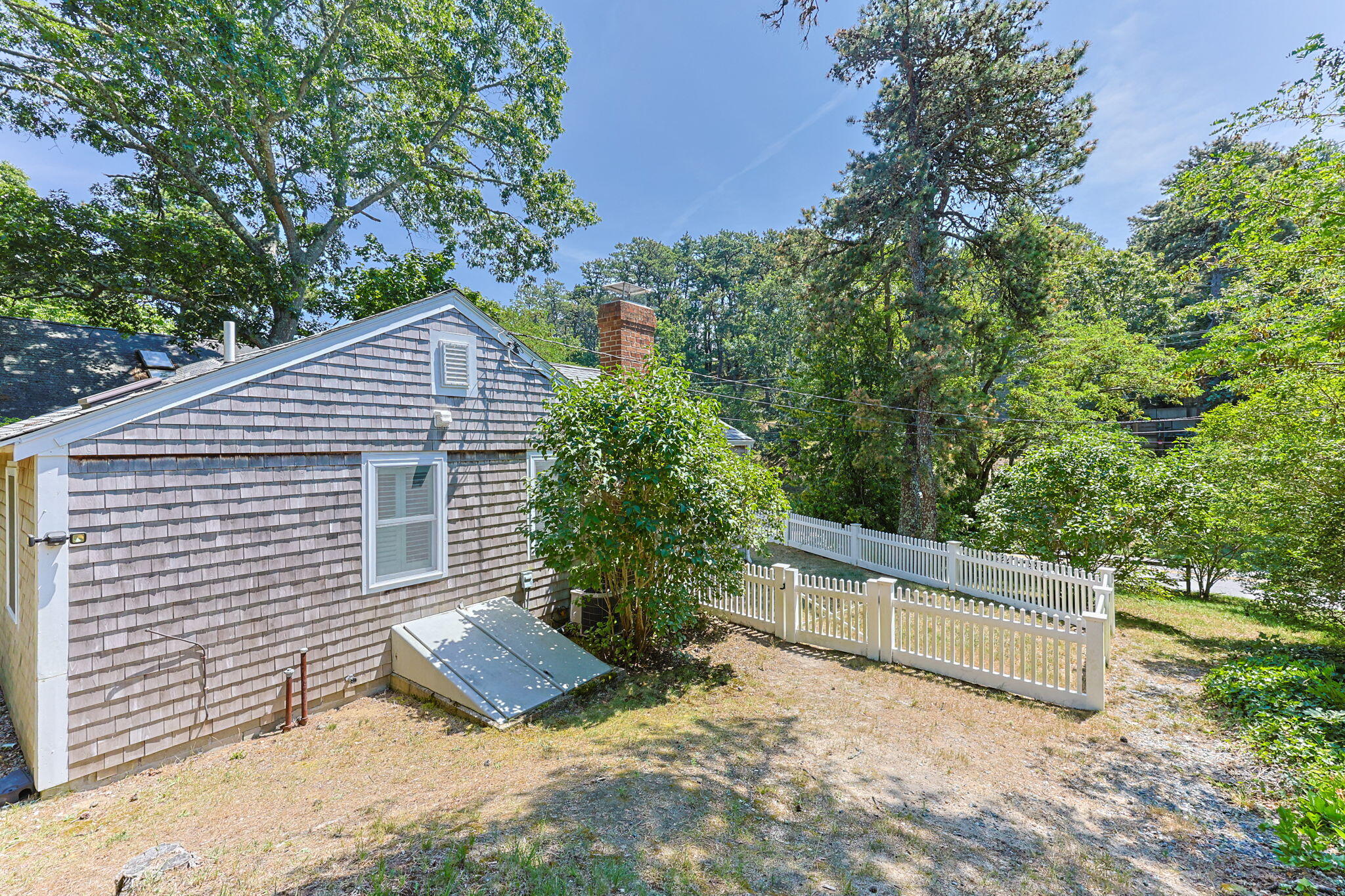 210 Chequessett Neck Road, Unit C Wellfleet, MA 02667 - Photo 31 of 37 a view of a house with a yard and a large tree