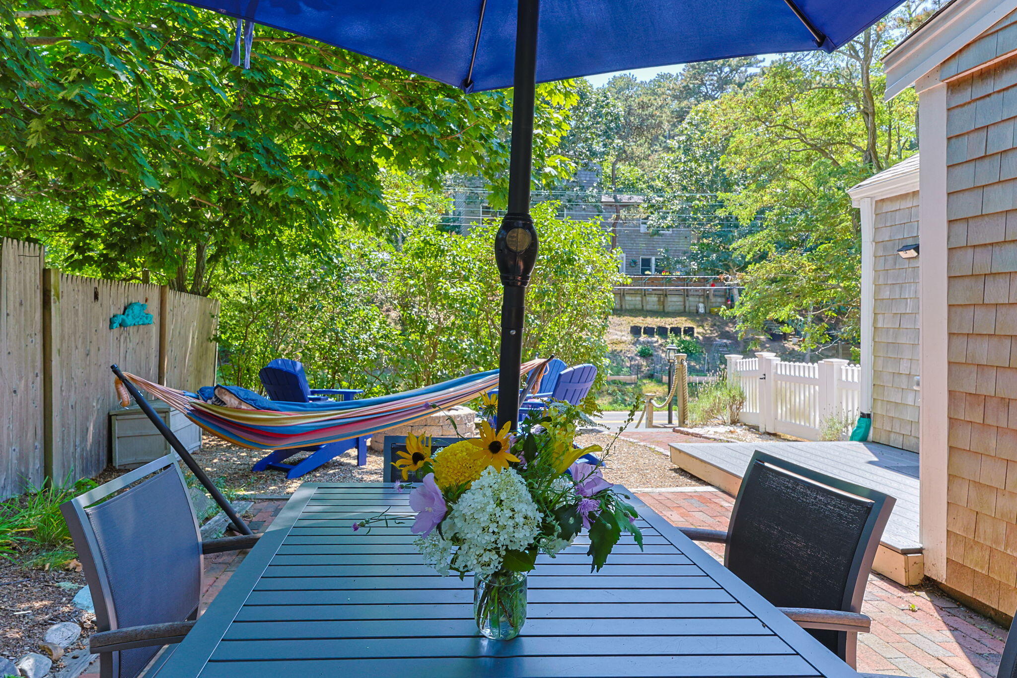 210 Chequessett Neck Road, Unit C Wellfleet, MA 02667 - Photo 34 of 37 a balcony with wooden floor table and chairs