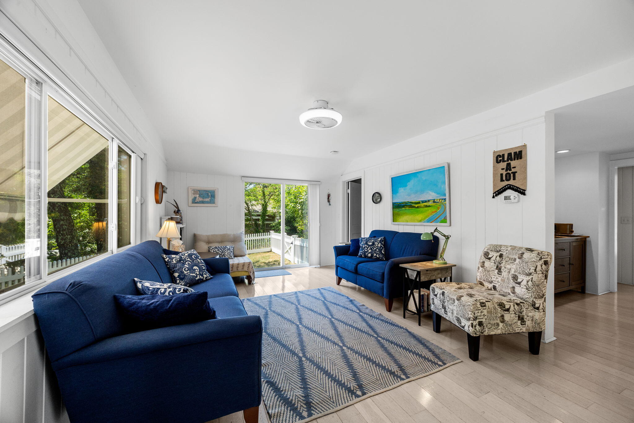 210 Chequessett Neck Road, Unit C Wellfleet, MA 02667 - Photo 7 of 37 a living room with furniture and large windows