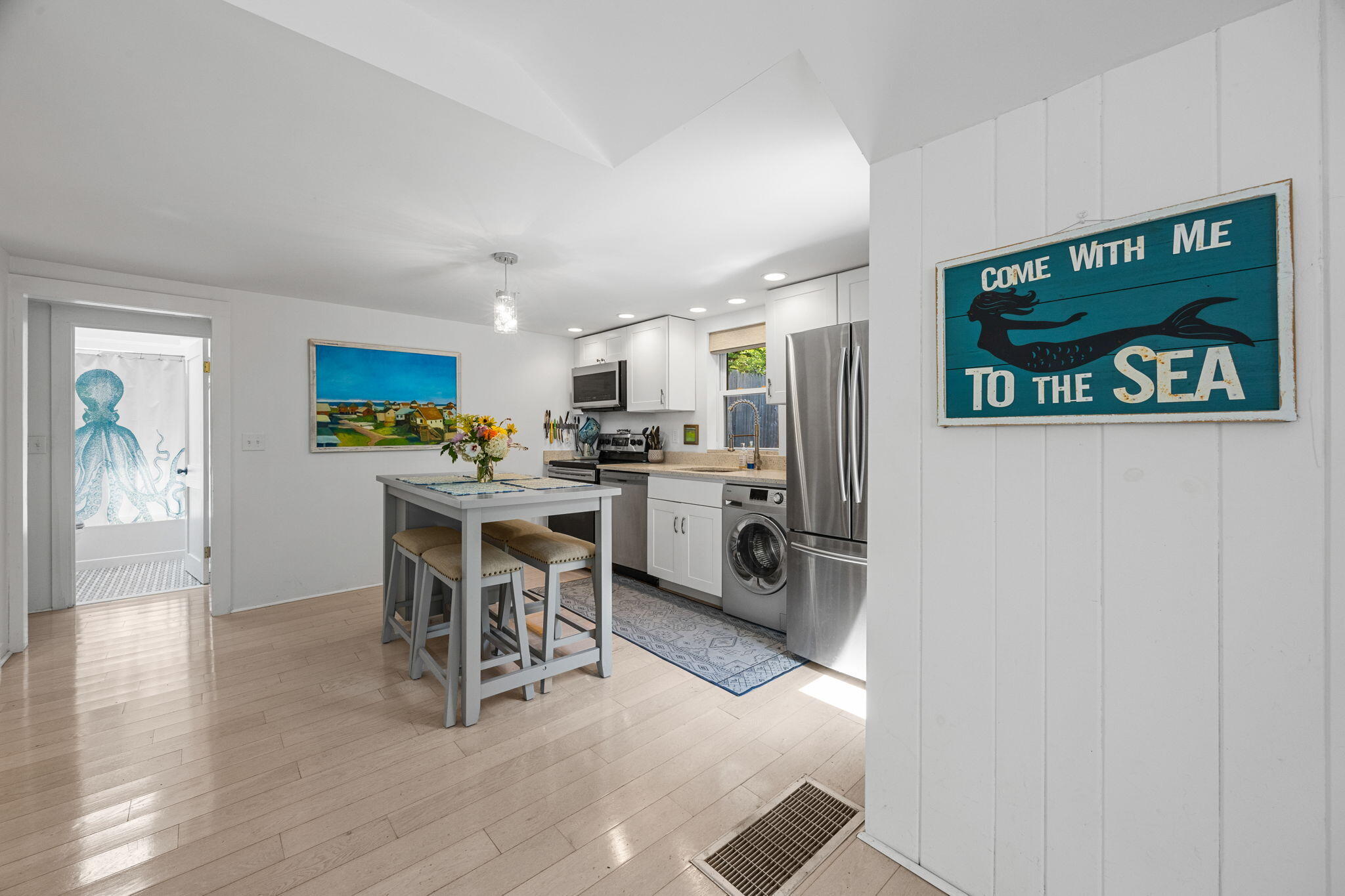 210 Chequessett Neck Road, Unit C Wellfleet, MA 02667 - Photo 10 of 37 a kitchen with a refrigerator and a table