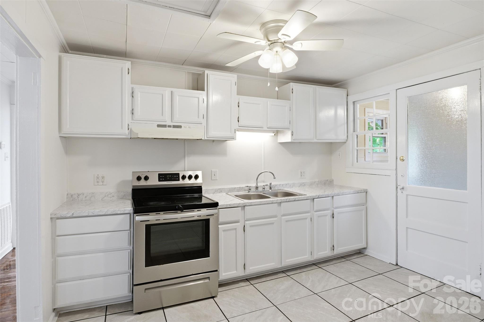 128 Ella Street Chester, SC 29706 - Photo 4 of 18 a kitchen with white cabinets and white appliances