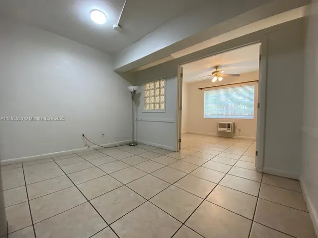 an empty room with a bathroom and a sink