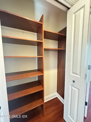 a view of walk in closet with empty racks