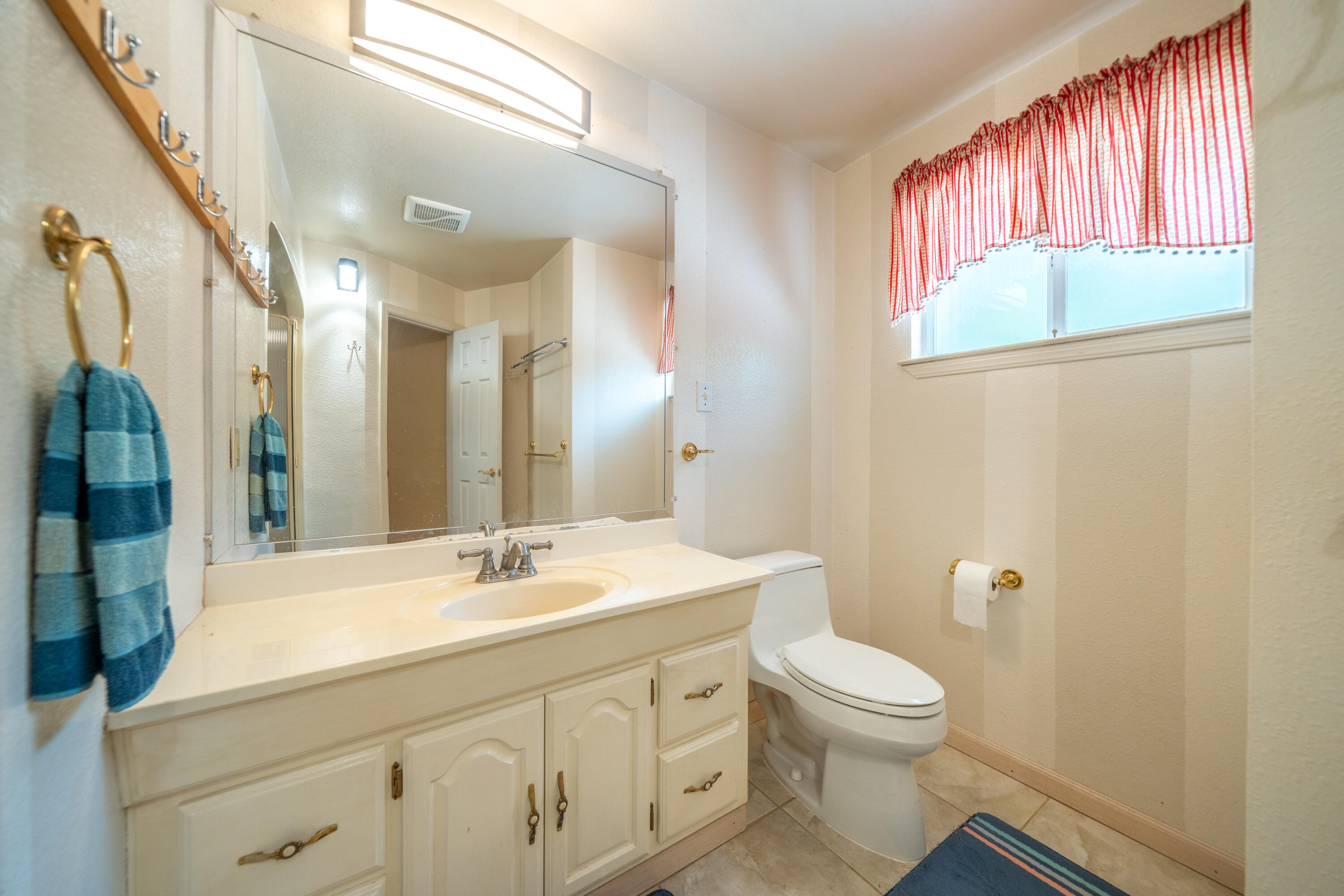 29061 South Cow Creek Road Whitmore, CA 96096 - Photo 14 of 27 a bathroom with a sink a toilet and a mirror