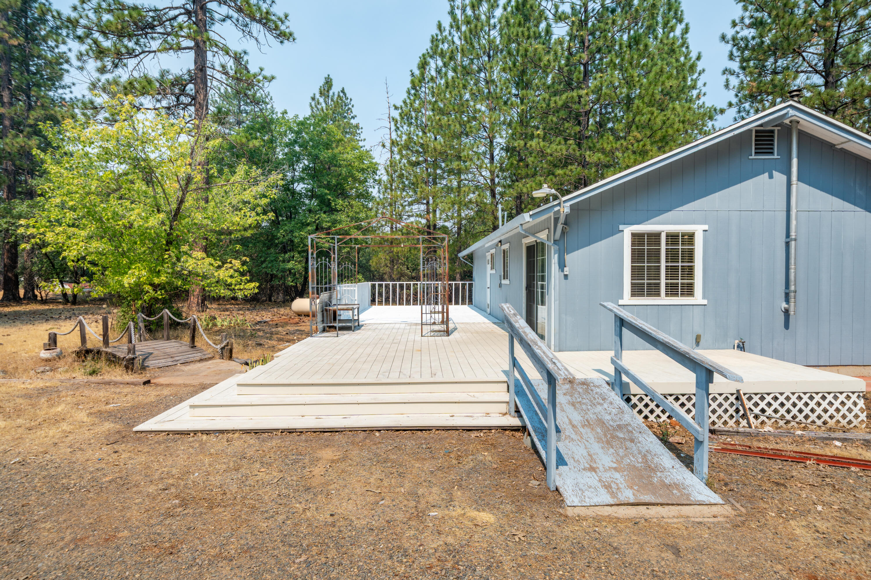 29061 South Cow Creek Road Whitmore, CA 96096 - Photo 18 of 27 a spacious bathroom with a tub and trees in the background