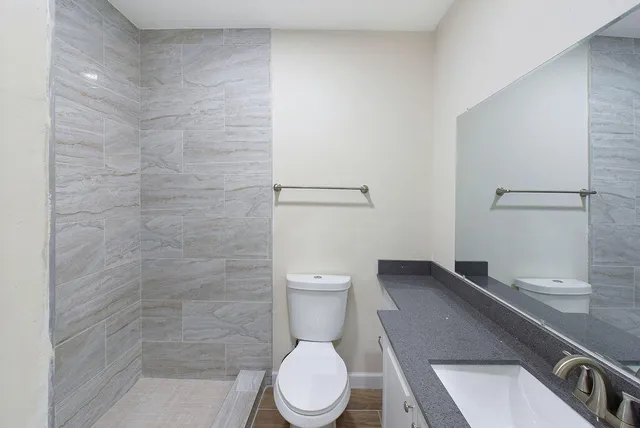 a bathroom with a toilet a sink and shower