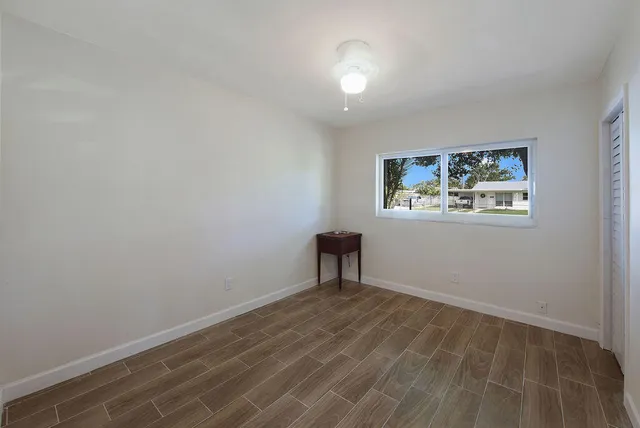 a view of a room with wooden floor and window