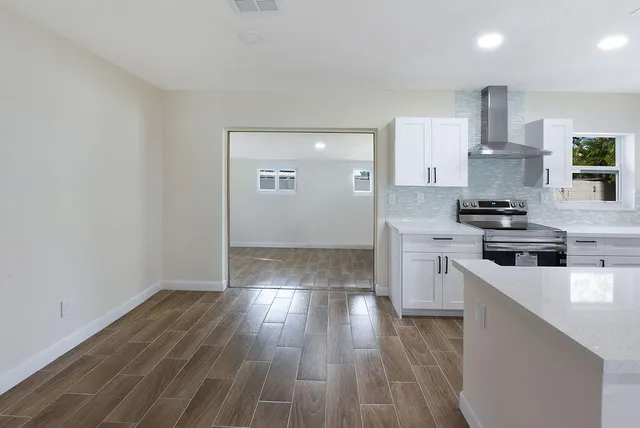 a kitchen with wooden floors and white appliances