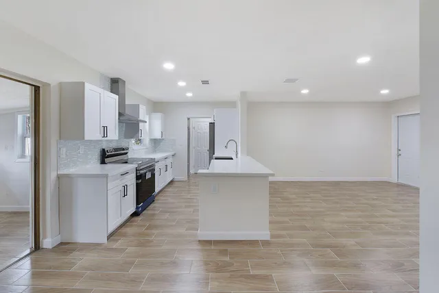 a large kitchen with cabinets and stainless steel appliances