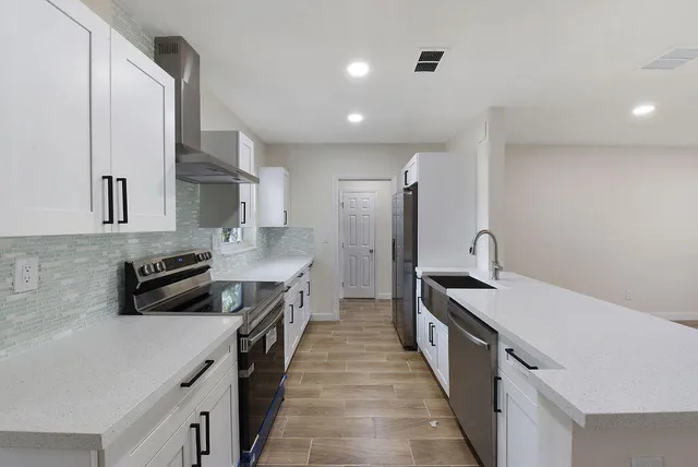 a kitchen with a sink stove and refrigerator