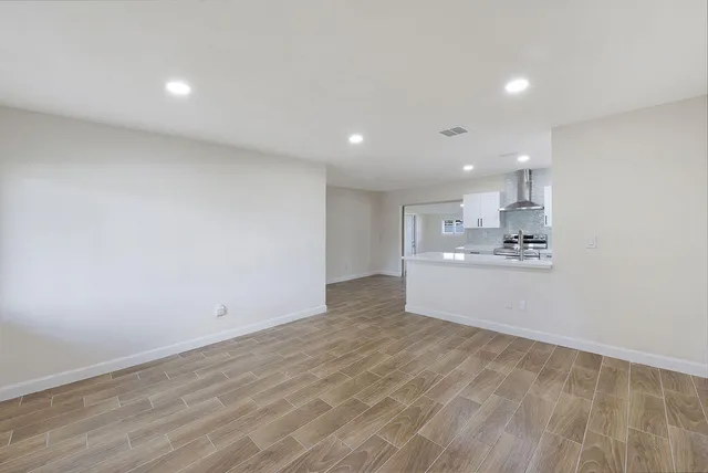 a view of a kitchen with wooden floor