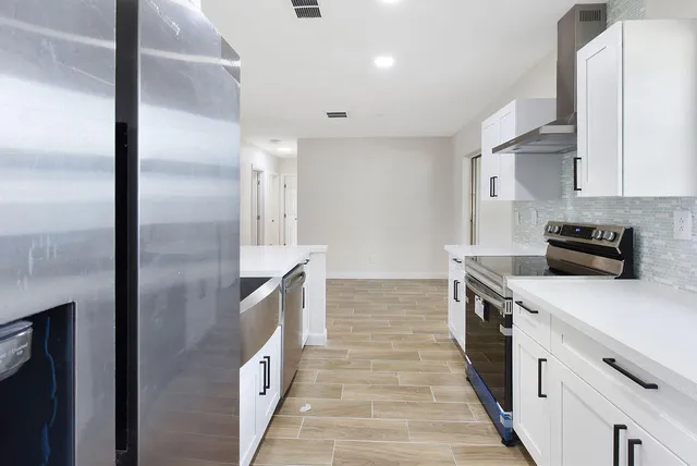 a kitchen with a refrigerator and a stove