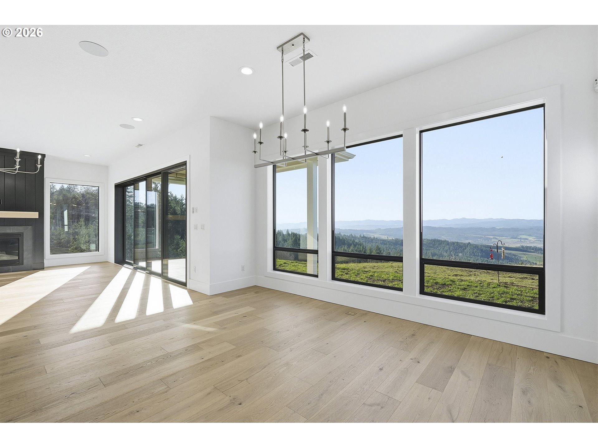 35921 Southwest Bald Peak Road Hillsboro, OR 97123 - Photo 16 of 48 a view of an empty room with wooden floor and a window
