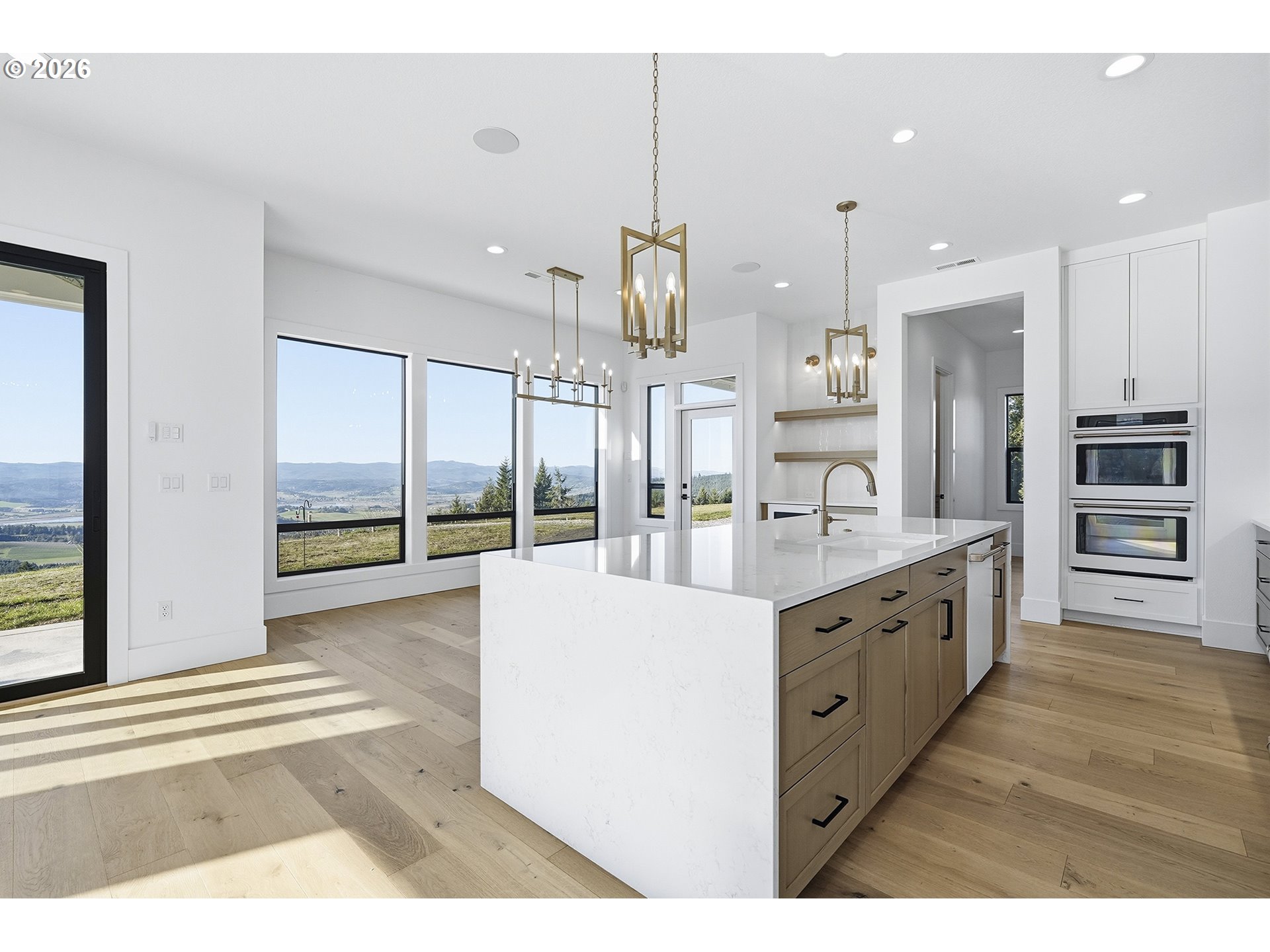 35921 Southwest Bald Peak Road Hillsboro, OR 97123 - Photo 10 of 48 a large kitchen with kitchen island a large counter space a sink appliances and cabinets