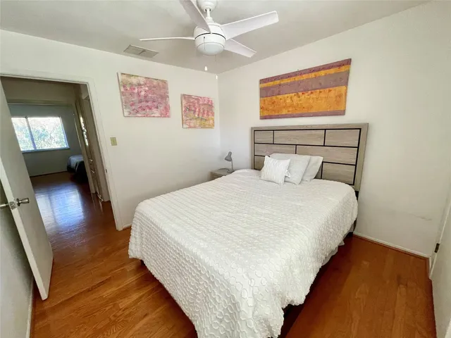 a bedroom with a bed and a painting on the wall