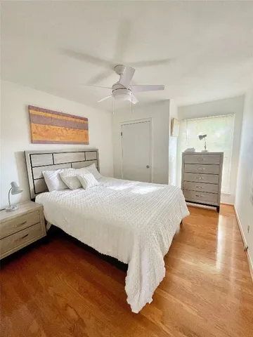 a bedroom with bed and window